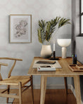 Load image into Gallery viewer, a desk with a chair and a vase with a plant on it
