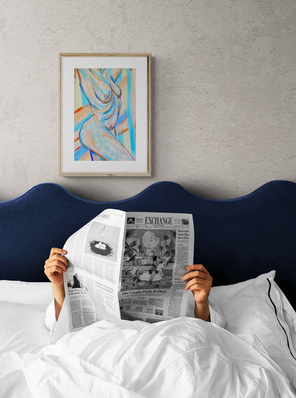 a person laying in bed reading a newspaper